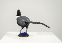 Cast in resin, a figurine of a pheasant posed on an indigo base points to a theme of human and animal interaction. Image 6