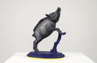 This tabletop indoor figurative sculpture of an animal is made of resin.