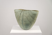 This contemporary ceramic vessel is moss green in color. Image 3