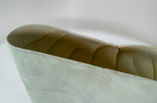 This contemporary ceramic vessel is moss green in color. Image 12