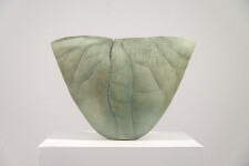 This contemporary ceramic vessel is moss green in color. Image 2