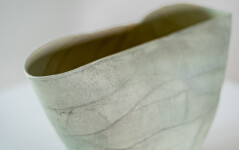 This contemporary ceramic vessel is moss green in color. Image 7