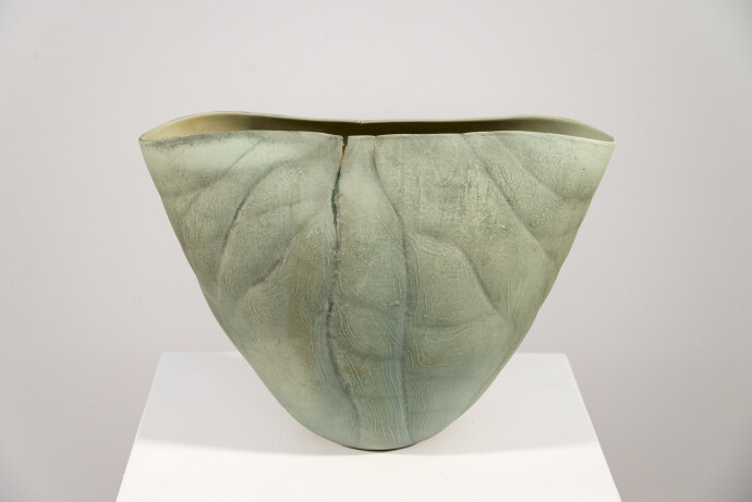 This contemporary ceramic vessel is moss green in color.