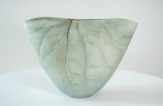 This contemporary ceramic vessel is moss green in color. Image 4