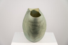 This contemporary ceramic vessel is moss green in color. Image 4