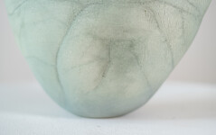 This contemporary ceramic vessel is moss green in color. Image 8