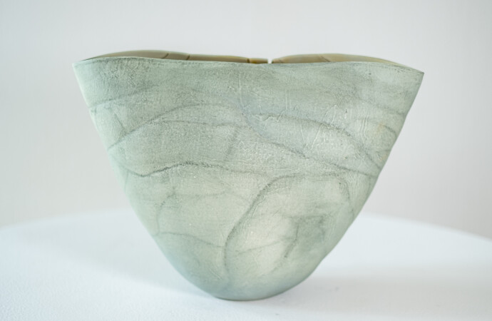 This contemporary ceramic vessel is moss green in color.