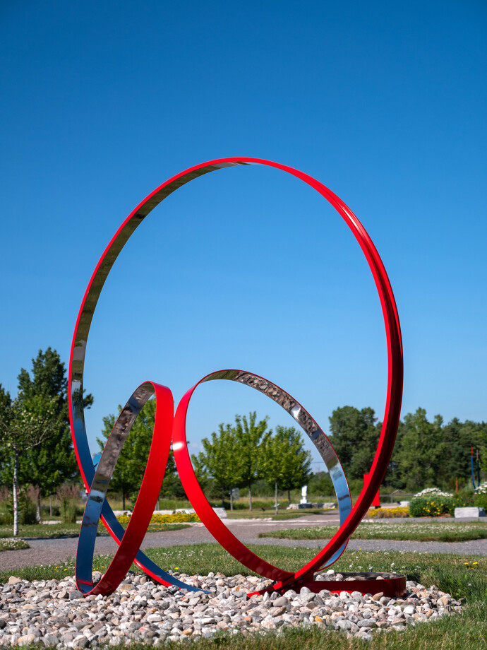 This elegant contemporary outdoor sculpture in bright poppy red was hand-forged from stainless steel by Philippe Pallafray.