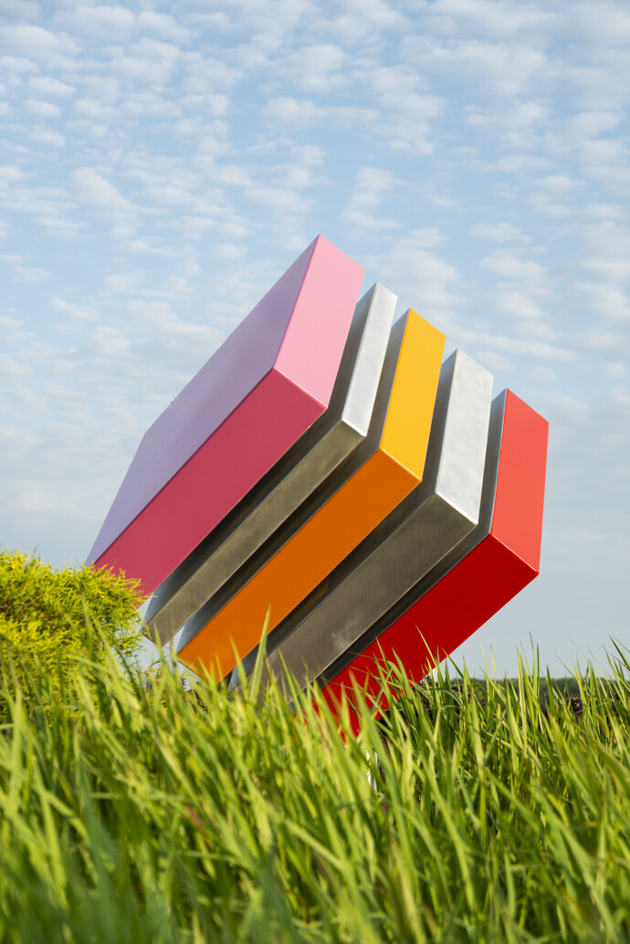 Philippe Pallafray’s latest sculpture—an eye-popping candy-coloured large steel cube—each stripe painted in bright red, orange and pink bala…