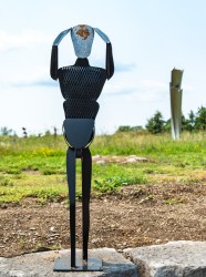 An imposing figure of a person standing, arms raised, hands on head, as if in turmoil is the latest subject of the inventive Canadian sculpt…