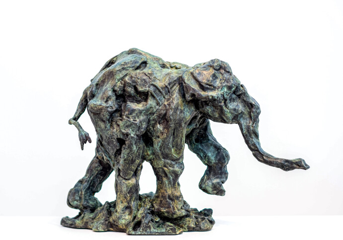 This delightful bronze statuette of a walking baby elephant is highly textured and finished with an elegant sepia patina.