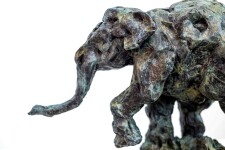 This delightful bronze statuette of a walking baby elephant is highly textured and finished with an elegant sepia patina. Image 6