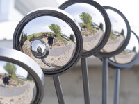 A multitude of polished mirrors shine as light bounces off them, reflecting the landscape and you. Image 7