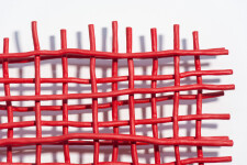 A layered grid of intersecting lengths of bent aluminum is painted in an eye-popping primary red by Shayne Dark. Image 6