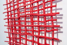 A layered grid of intersecting lengths of bent aluminum is painted in an eye-popping primary red by Shayne Dark. Image 4