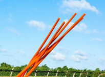 This contemporary orange-colored metal outdoor sculpture is the work of Shayne Dark. Image 5