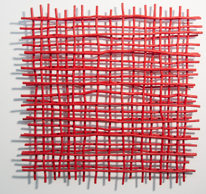 A layered grid of intersecting lengths of bent aluminum is painted in an eye-popping primary red by Shayne Dark.