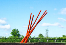 This contemporary orange-colored metal outdoor sculpture is the work of Shayne Dark. Image 4