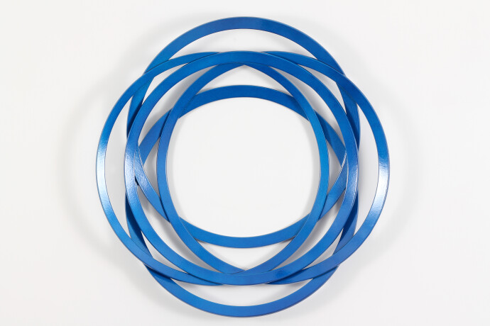 An arresting abstract wall sculpture in bright blue is one of a series created by Canadian artist Shayne Dark.