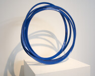 Brilliant blue circles are layered to effect motion in this elegant steel standing sculpture by Canadian master sculptor Shayne Dark. Image 3