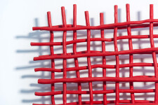 A layered grid of intersecting lengths of bent aluminum is painted in an eye-popping primary red by Shayne Dark. Image 7