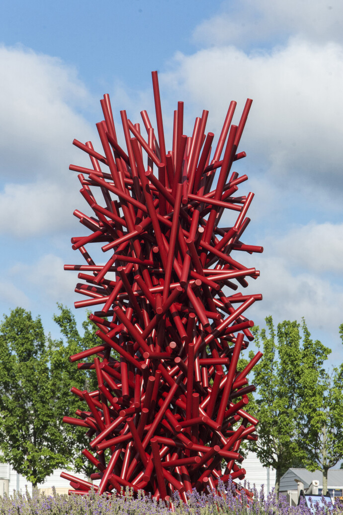 This imposing, rich red metal sculpture by Canadian artist, Shayne Dark is part of the ‘Entangled Series’ he has worked on for years.