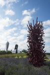 This imposing, rich red metal sculpture by Canadian artist, Shayne Dark is part of the ‘Entangled Series’ he has worked on for years. Image 2