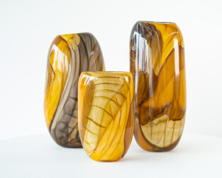 These gold, brown, contemporary, hand-blown, glass vessels are made by Canadian artist Susan Rankin.