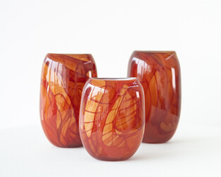 These red, orange, contemporary, hand-blown, glass vessels are made by Canadian artist Susan Rankin.