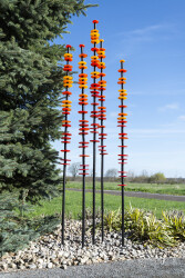 The colours of a hot summer sun—a juicy orange and a golden yellow are captured in glass in this compelling outdoor sculpture by Susan Ranki…