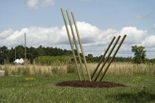 Solid steel rods coated in brilliant brass appear to rise out of the earth and reach for the sky in this dramatic sculpture by Canadian arti… Image 6